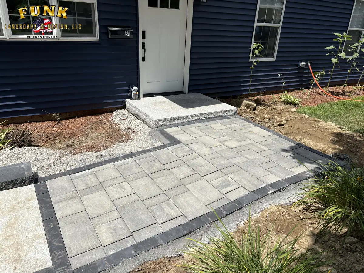 Light paver walkway and front step landing with dark paver border