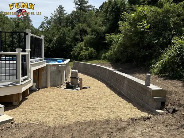 Retaining wall beside a hot tub deck, built by Funk Landscape & Design