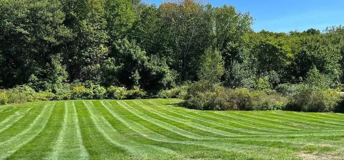 Landscape maintenance on a large mown property in Worcester County, MA by Funk Landscape & Design