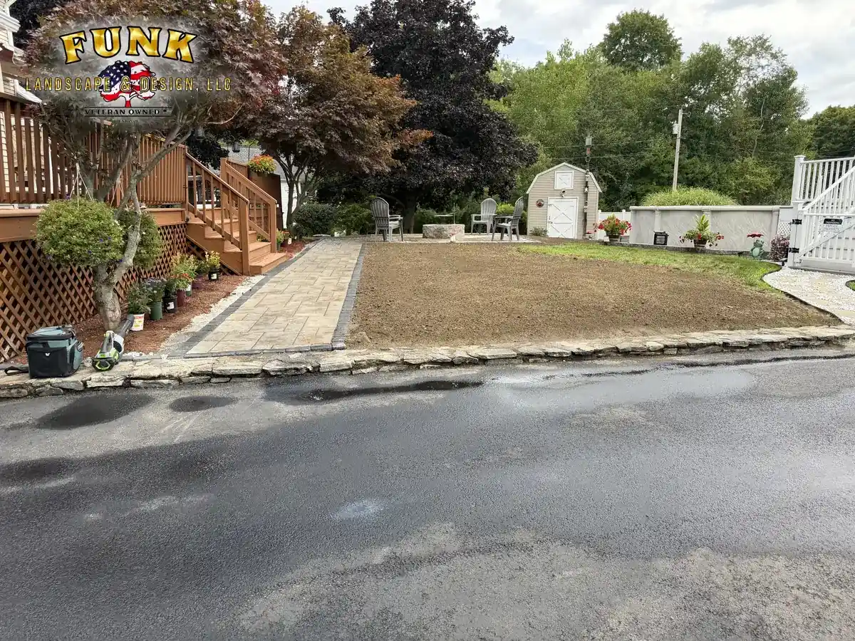 New paver walkway and freshly graded lawn installation at a Worcester County home by Funk Landscape & Design
